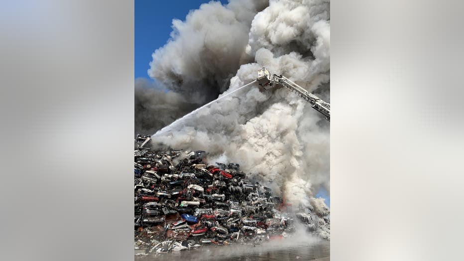 Firefighters battle a blaze at Northern Metals in Becker, Minn. two days after it started. 