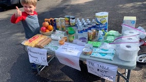 Four-year-old Minnetonka, Minn. boy sets up supplies table to help neighbors