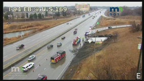 Semi carrying 40,000 pounds of dog food rolls over along I-94 in Brooklyn Park, Minn.