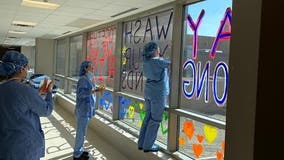 St. Joseph's Hospital staff write encouraging messages on windows