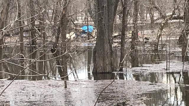 Thanks to citizen's tip, officials rescue homeless person from flooded camp