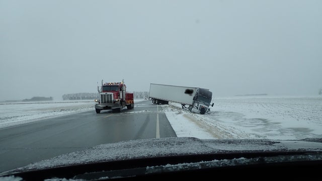 Plow and semi blown off icy road as winter weather persists in northwest Minnesota