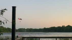 Minnesota State Patrol helicopter draws water from Minneapolis lake to fight fire