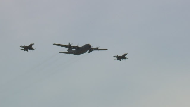 Health care workers fighting COVID-19 watch flyover from Minnesota National Guard