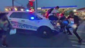 Video shows Detroit police cruiser driving through demonstrators after being surrounded during protests