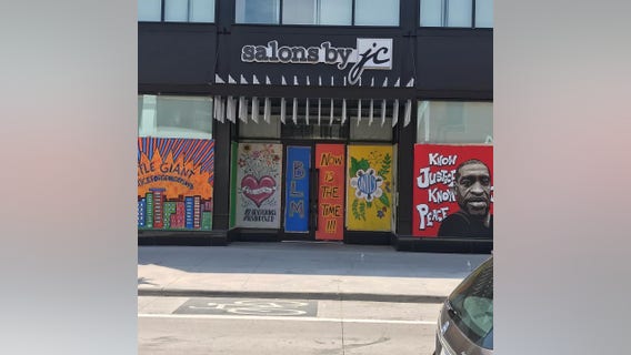 Artists paint murals honoring George Floyd on plywood protecting businesses around Minneapolis