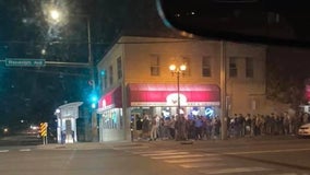 Photo shows long line outside St. Paul bar as college students return to campus