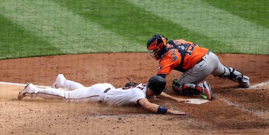 Max Kepler slides into home plate for the first run of the game