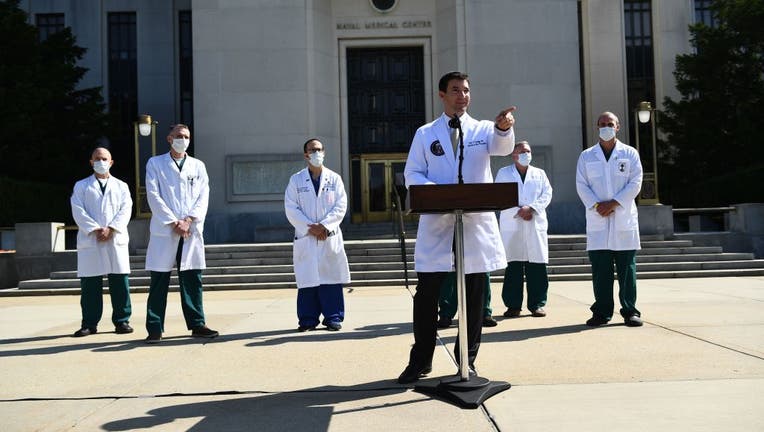 FILE - White House physician Sean Conley answers questions surrounded by other doctors, during an update on the condition of US President Donald Trump, on October 4, 2020, at Walter Reed Medical Center in Bethesda, Maryland.