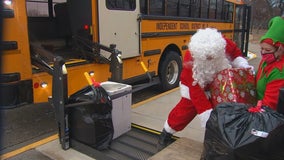 St. Francis school bus drivers help Santa with present deliveries