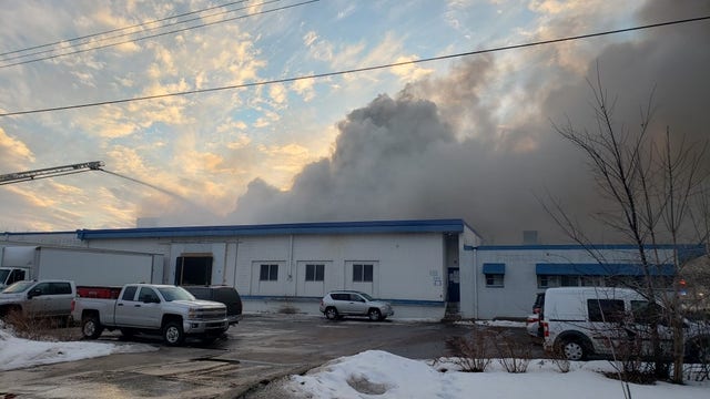 Section of warehouse partially collapses as crews battle large fire in north Minneapolis