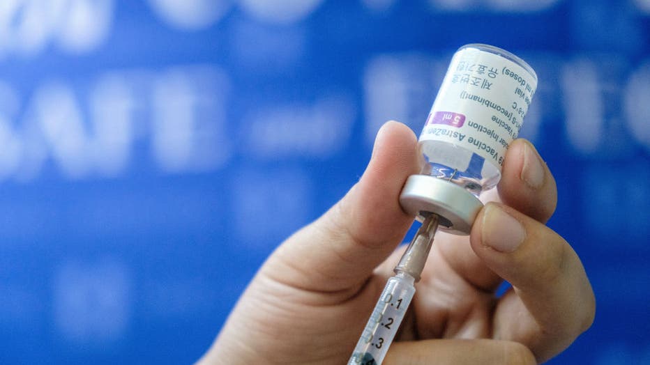 A medical workers prepares a dose of AstraZeneca vaccine