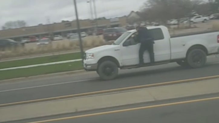 Man who drove off with officer clinging to truck charged with 4 felonies - Vimarsana News