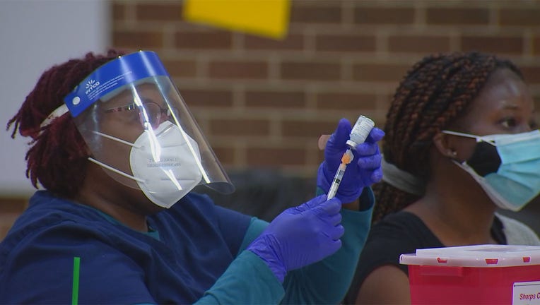 health care worker preparing to administer the COVID-19 vaccine.