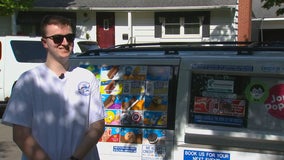 Man handing over keys to family-run Twin Cities ice cream truck to little sister