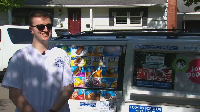Man handing over keys to family-run Twin Cities ice cream truck to little sister