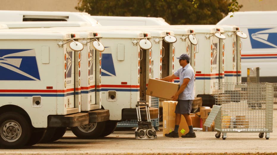 db7c0c87-Mail carriers loading their trucks at the United States Postal Service in Van Nuys, California for story on USPS delays