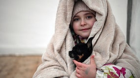 Photos: Ukrainians fleeing war 'can't leave' pets behind