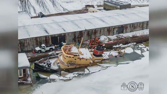 Retired tugboat remains partially submerged in Duluth port