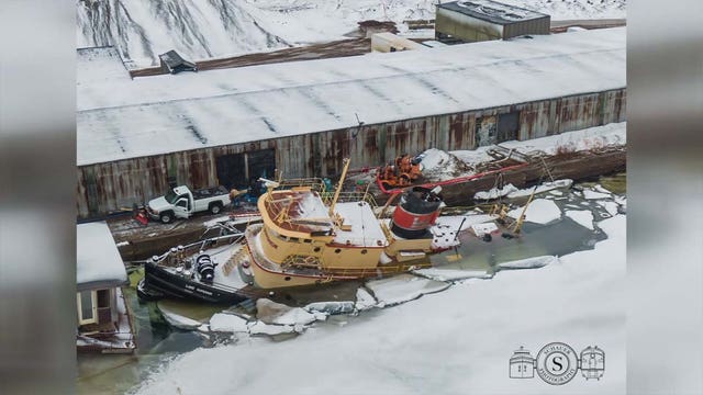 Retired tugboat remains partially submerged in Duluth port