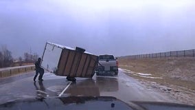 Deputy helps flip over trailer on side of southern Minnesota highway