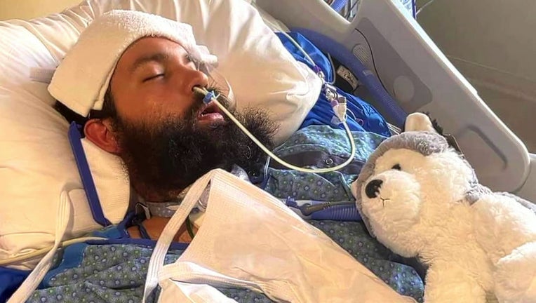 A photo of Gabe Tauscher in a hospital bed