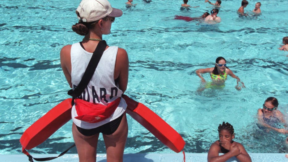 f684cde0-The life and times of a lifeguard at the busy Como Pool. Lifeguard Kelly Thune, a junior at the U of MN., kept a watchfull eye on the swimmers in Como Pool. Thune has been a guard at the St. Paul pool for the past three years.