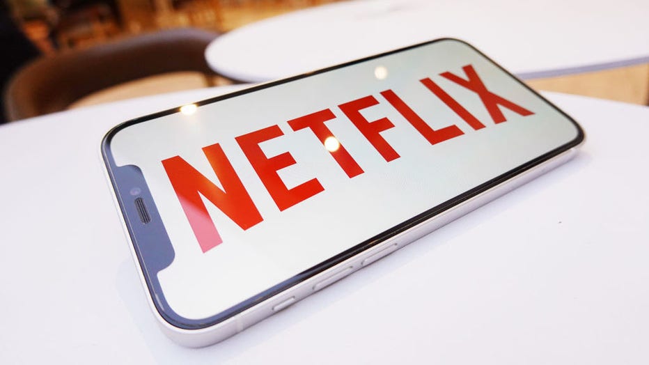 In this photo illustration, a Netflix logo is displayed on