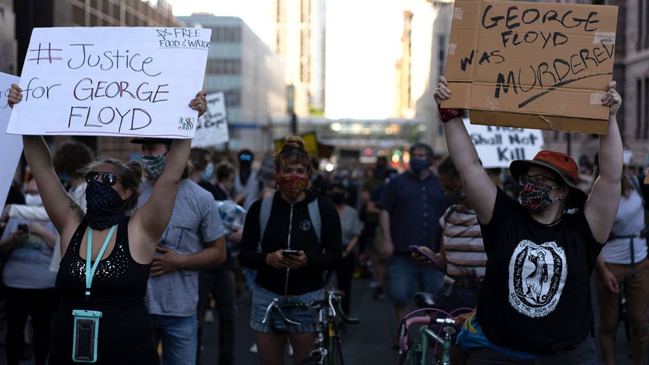 Protesters hold signs during demonstrations following the murder of George Floyd in Minneapolis. (Photo by Fox 9 Producer Samy Verne)