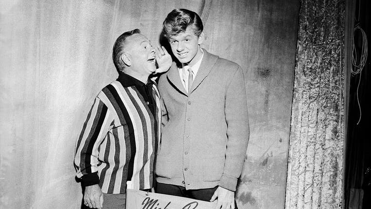 Actor Mickey Rooney Whispering to His Son on Acting Tips