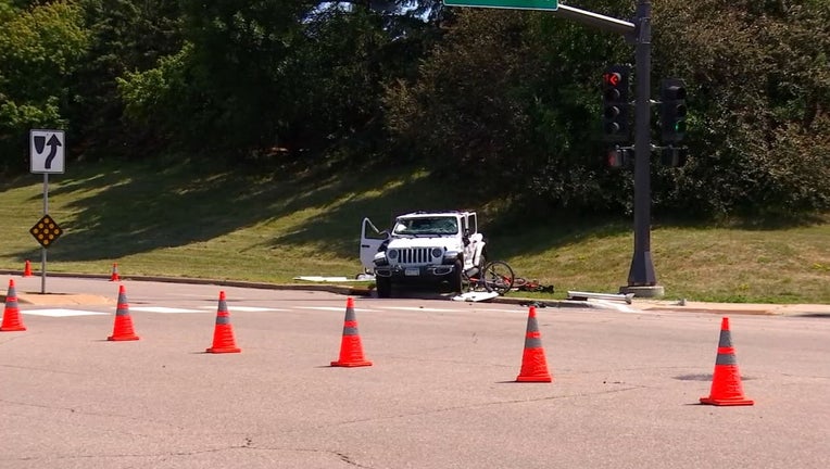 street traffic cones, damaged white car and bikes