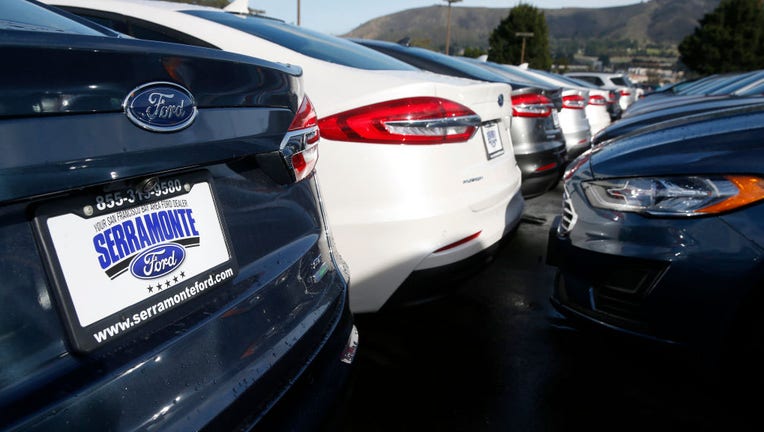 New cars are parked in the lot at the Serramonte Ford dealership in Colma, Calif. on Friday, Dec. 14, 2018. Beginning Jan. 1 auto dealerships will be required to affix temporary license plates to every vehicle sold and before it drives off the lot