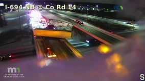 Crash leaves semi trailer hanging over I-694 overpass