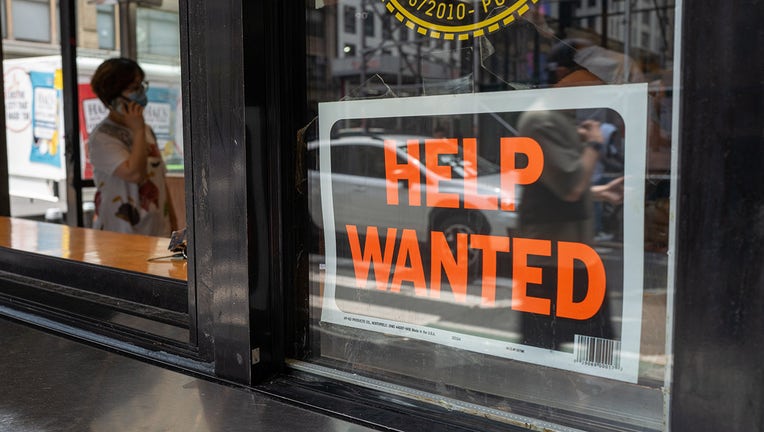 A "help wanted" sign is displayed in a window in Manhattan on July 28, 2022 in New York City.