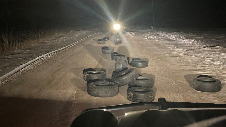 tires scattered on dirt road