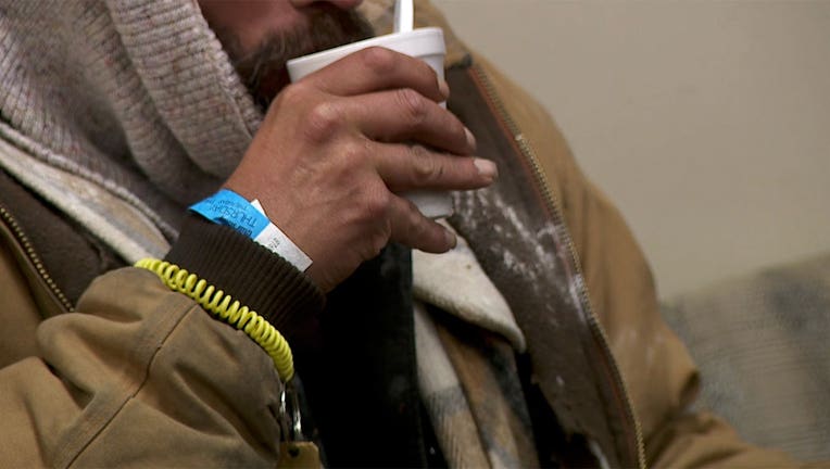 A man sips a coffee at a Ramsey County Winter Warming Space in downtown St. Paul on Thursday, Dec. 23.