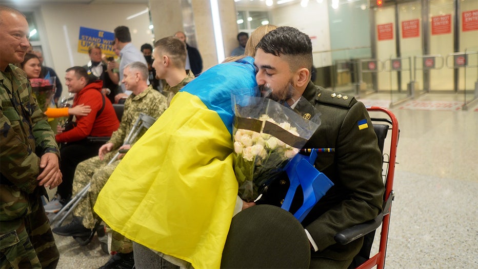 Roman Matvisiv, an officer in the Ukrainian military, is embraced by a supporter after arriving at the Minneapolis-St. Paul airport on Sunday, Oct. 28. (FOX 9)