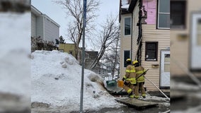 Passerby helps put out Duluth house fire by shoveling snow onto it