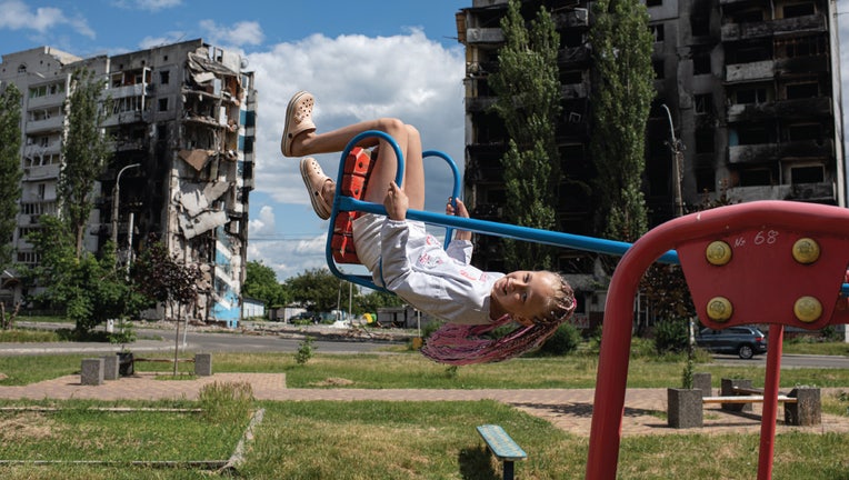 A girl on a swing. Borodianka, Kyiv region, Ukraine. June 15, 2022. (Photo by Alexey Furman)