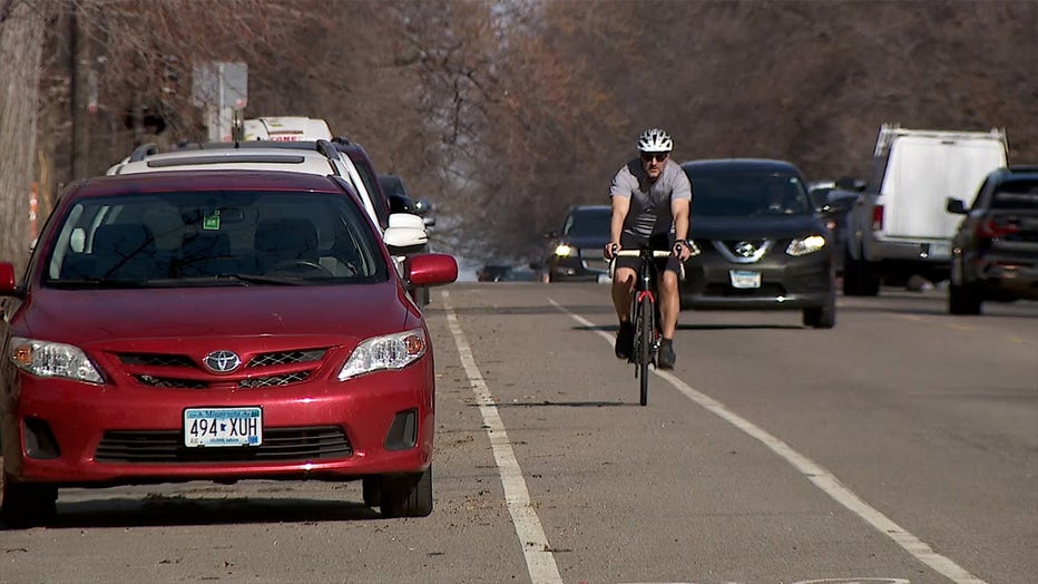 A man rides a bicycle in the bike lane on Summit Avenue in St. Paul. (FOX 9)