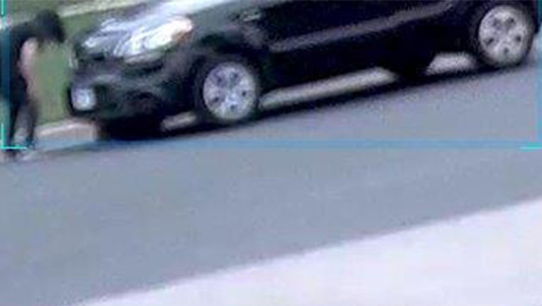 Bloomington Police published still frames from a video showing a driver placing a cat under the front passenger tire of a car and then running it over. They are asking for the public’s help in identifying the suspect. (Image provided)