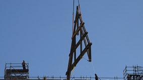 Cranes hoist massive oak trusses onto Notre Dame Cathedral 4 years after fire