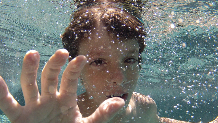 An eight year old boy swimming underwater in his back yard family swimming pool. Connecticut, USA. Photo Tim Clayton (Photo by Tim Clayton/Corbis via Getty Images)