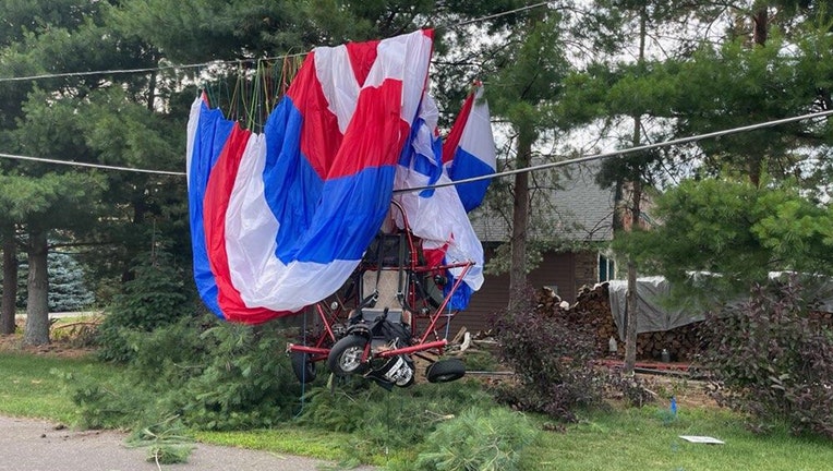 A 'powered parachute' caught in power lines after a collision in Chetek, Minnesota. The incident resulted in significant injuries for the pilot. (Image courtesy of the Chetek Police Department).