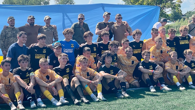 FC Minaj players and Cincinnati United North 06B team gather with Ukrainian veterans for a group photo after a spirited match at the USA Cup. (FOX 9)