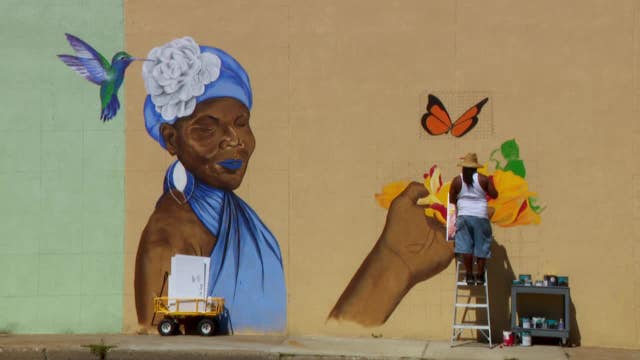 Local artist transforms north Minneapolis wall with 'All Seasons' mural