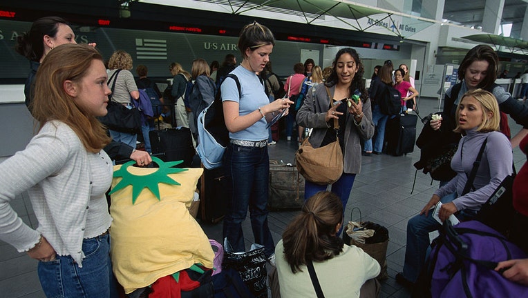 Young-women-wait-at-airport.jpg