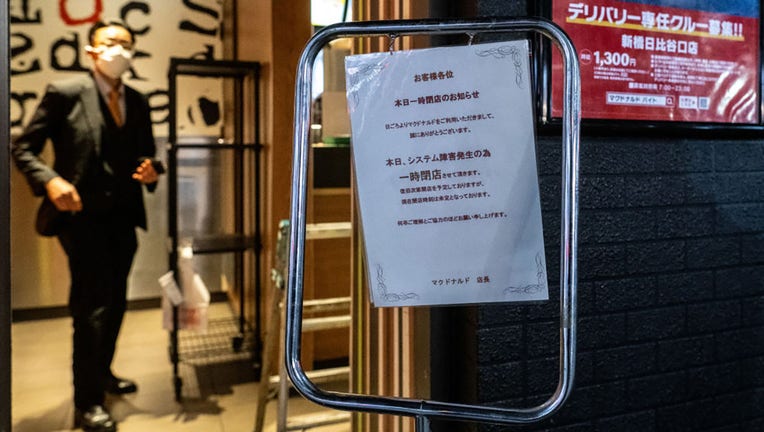 A temporary closure notice is pictured from a McDonalds in Shimbashi district of Tokyo on March 15, 2024. (Photo by PHILIP FONG/AFP via Getty Images)