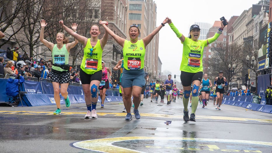 FILE - Runners celebrate at the finish line at the Boston Marathon 2023 on April 17, 2023 in Boston, Massachusetts. (Photo by Lauren Owens Lambert/Anadolu Agency via Getty Images)