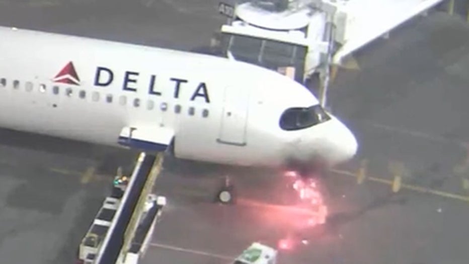 photo showing nose of delta plane on fire